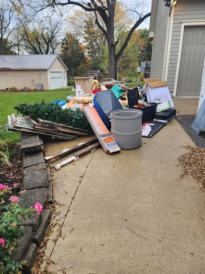 Dumpster being loaded with debris for Roofing Dumpster Rental in Williamston